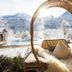 Berghotel Rehlegg in Ramsau: circular outdoor daybed with snowy mountain view and pool