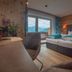 Hotel Tipotsch in Stumm: cozy twin room with mountain-view window and wood-paneled walls