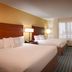 Fairfield Inn & Suites by Marriott Boise Nampa guest room with two beds, desk, and window view in Nampa