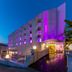 Ideal Pearl Hotel Adults Only in Marmaris, lit purple at dusk with a boardwalk entrance