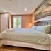 Cozy Home Near Transit & Hillcrest Mall with Free Parking bedroom in Richmond Hill with wall-mounted TV and window