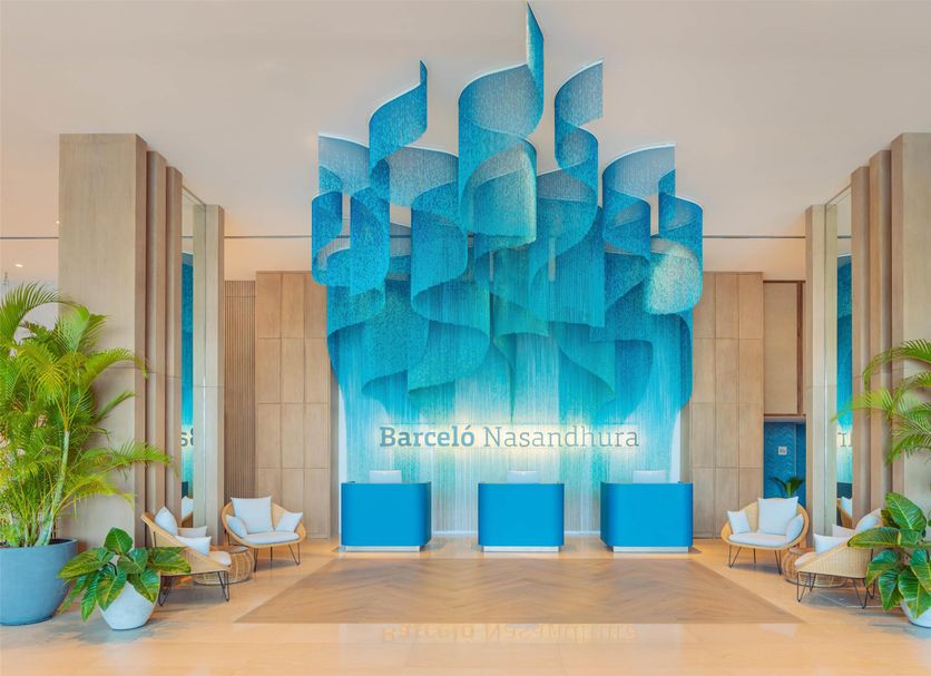 Barceló Nasandhura Malé lobby with blue sculptural wall art and seating, Malé
