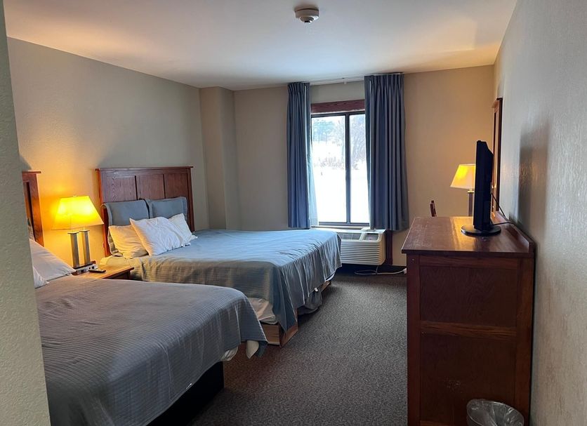 Pleasant Night Inn Carthage Near Fort Drum guest room with two beds, window, and dresser