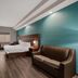 Best Western Plus Bowie Inn & Suites room with king bed, sofa, desk and wall-mounted TV in Bowie