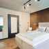 art Hotel Tucholsky Bochum guest room with double bed, wood accent wall and modern lighting