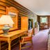 Highland Hills Motel & Cabins in Boone guest room with two beds, desk, TV and log cabin walls