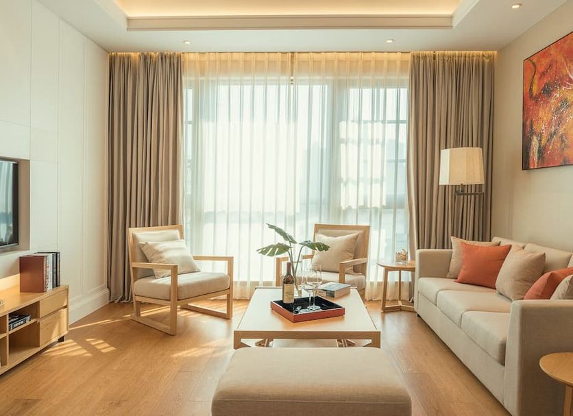 Residence G Shenzhen guest room with sofa, armchairs, coffee table and floor-to-ceiling window