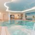 Hotel Schloss Dürnstein indoor pool with waterfall and river view in Durnstein