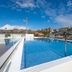 Rooftop pool at Leonardo Hotel San Sebastián in San Sebastian with city and hillside views