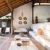 Pousada Outeiro in Trancoso, covered open-air lounge with white sofa, wooden deck and rustic decor