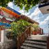 Blue Angel Resort in Cozumel with colorful dive shop mural, stairs, and tropical landscaping