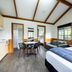 NRMA Ballarat Holiday Park room with twin beds, sofa, dining table and kitchen area in Ballarat