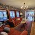 Landhotel Schönblick in Bad Herrenalb living room with sofa, piano, TV and patterned wallpaper
