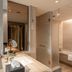 Grand Pacific Hotel Ningbo bathroom with glass shower, soaking tub, and vanity in Ningbo