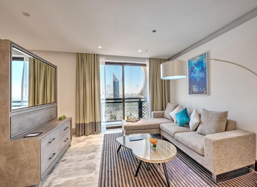 Arjaan by Rotana - Dubai Media City suite with city view, sofa, coffee table and balcony in Dubai
