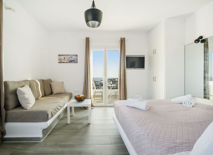 Oniropetra Apartaments in Plintri, bright room with sofa bed, double bed, and balcony view