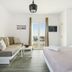 Oniropetra Apartaments in Plintri, bright room with sofa bed, double bed, and balcony view