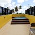 Flat Mar do Cabo Branco Residence in João Pessoa: rooftop hot tub with palm and ocean view