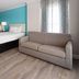 Howard Johnson Plaza by Wyndham Ocean City Oceanfront room with two beds, sofa and bright window