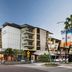 Grand Hotel and Apartments Townsville exterior with balconies and street-level shops in Townsville