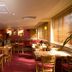Premier Inn Aberdeen City Centre restaurant with wooden tables, red carpet, and window blinds in Aberdeen