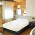 Hotel Guleryuz in Antalya guest room with two beds, wall lights, air conditioning, and a kettle tray