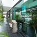 OYO 90151 Hill Inn Batu Caves exterior walkway with glass windows and potted plants