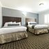 Hollywood Palms Inns & Suites in Los Angeles guest room with two beds and window light