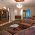 Dansereau House in Thibodaux guest room with chandelier, sofa, armchair, TV cabinet and bed