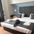 New Wilmington Hotel Eastbourne guest room with king bed, bedside tables, and lamps