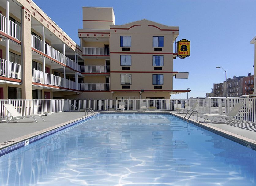 Super 8 by Wyndham Atlantic City outdoor pool with sun loungers and surrounding hotel buildings