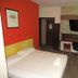The Bull And Bush Hotel Kingston room with double bed, desk, chair and wall-mounted TV in Kingston upon Thames