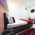 Oyo 8959 New Dk Palace Chandigarh guest room with double bed, sofa, wall TV and air conditioner