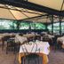 Hotel Ristorante Vecchia Riva in Varese outdoor terrace dining with white tablecloth tables under a canopy