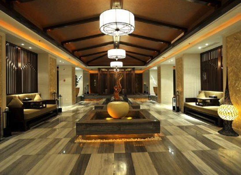 Wuxi Idea Garden Hotel lobby in Wuxi with central fountain, pendant lights, and lounge seating