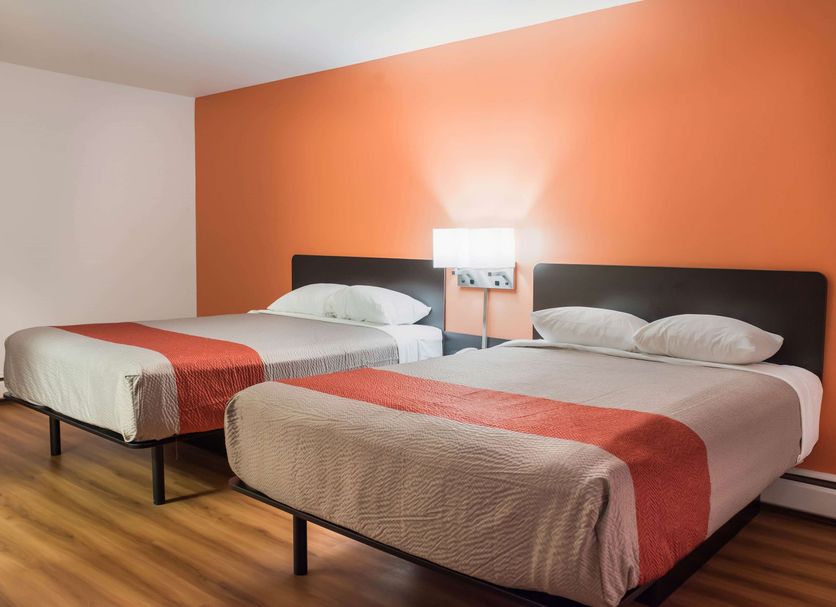 Motel 6 Fort St. John, B.C. room with two beds against an orange accent wall