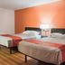 Motel 6 Fort St. John, B.C. room with two beds against an orange accent wall