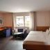 Landhotel Pfrondorfer Mühle in Nagold guest room with double bed, desk, sofa and window view