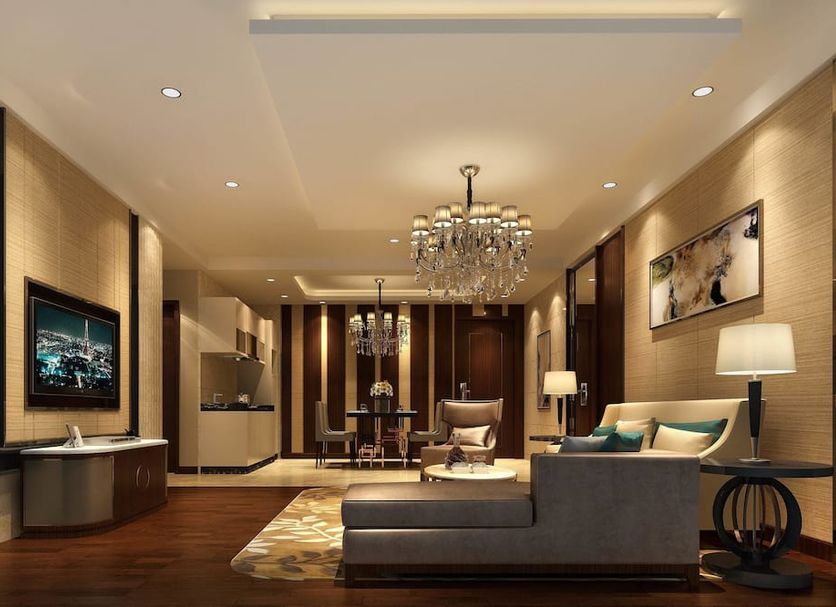 Boudl Al Sahafa Riyadh living room with chandelier, sofa, chair and dark wood flooring