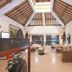 Mirah Hotel & Resort Banyuwangi lobby with vaulted wooden ceiling and seating area