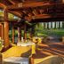 Open-air dining terrace at Agriturismo La Sovana in Sarteano with garden views and set tables