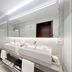 Grand Hotel des Bains in Lavey-Morcles bathroom with double sinks, walk-in shower and large mirror