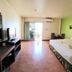Opey De Place Pattaya guest room with king bed, TV, desk, and balcony door