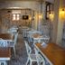 Olea Leya Hotel in Ayvalik dining room with wooden tables and white wrought-iron chairs