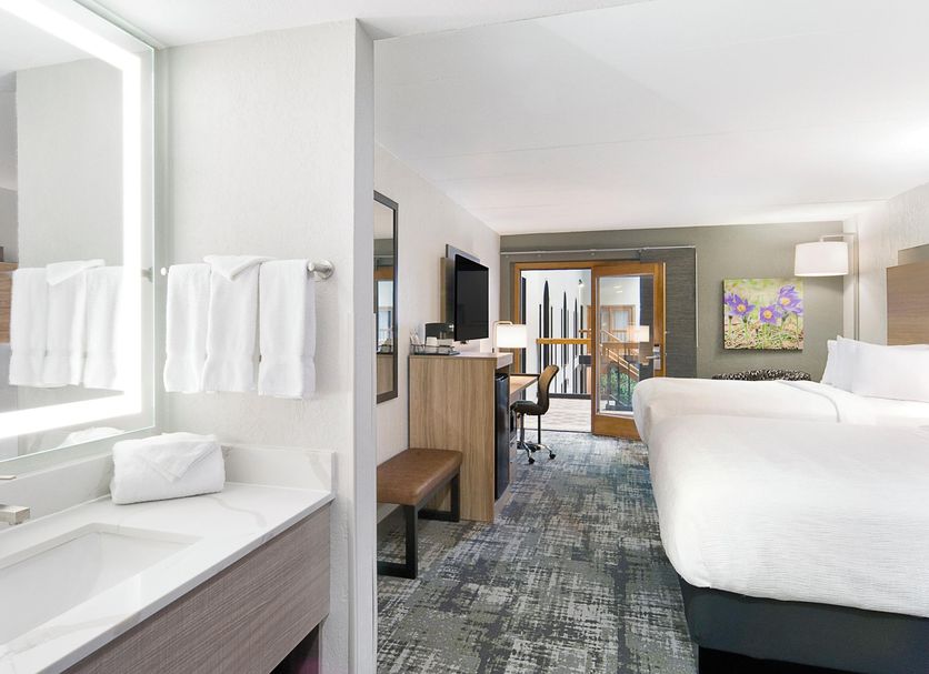 Ramkota Hotel Pierre in Pierre guest room with vanity, king bed and balcony view
