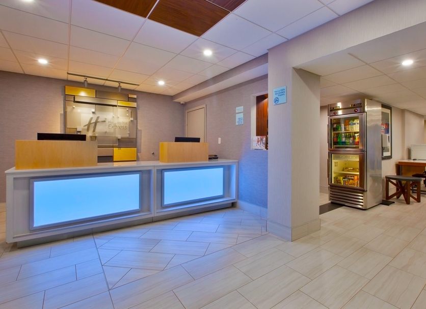 Holiday Inn Express Fairfax - Arlington Boulevard lobby front desk and seating area in Fairfax