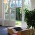 Bitter en Zoet in Veenhuizen lobby with large windows, potted tree, and wooden bench