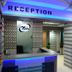 Nice Guest House Mumbai reception desk with blue lighting and mirrored wall
