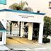 Casa Blanca Hotel in Orange with white entrance arch, teal roof accents, and stairway beside the building