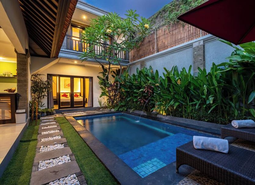 De' Bharata Bali Villas in Kuta: private courtyard pool with lounge chairs and tropical greenery